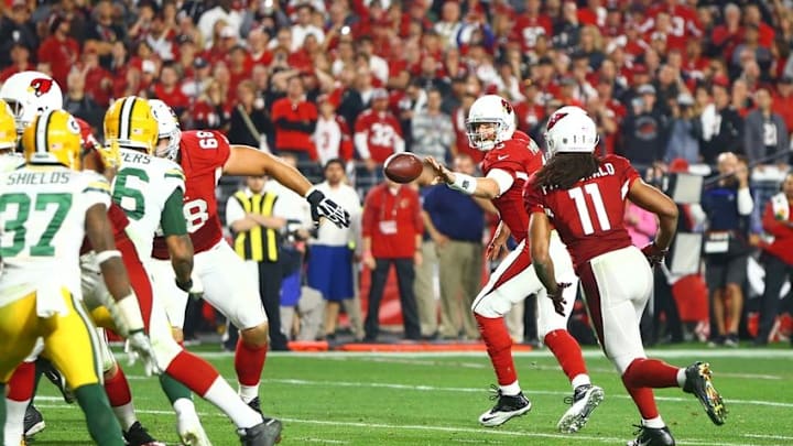 Jan 16, 2016; Glendale, AZ, USA; Arizona Cardinals quarterback Carson Palmer (3) throws a shovel pass to wide receiver Larry Fitzgerald (11) to score a touchdown in overtime against the Green Bay Packers during an NFC Divisional round playoff game at University of Phoenix Stadium. Mandatory Credit: Mark J. Rebilas-USA TODAY Sports