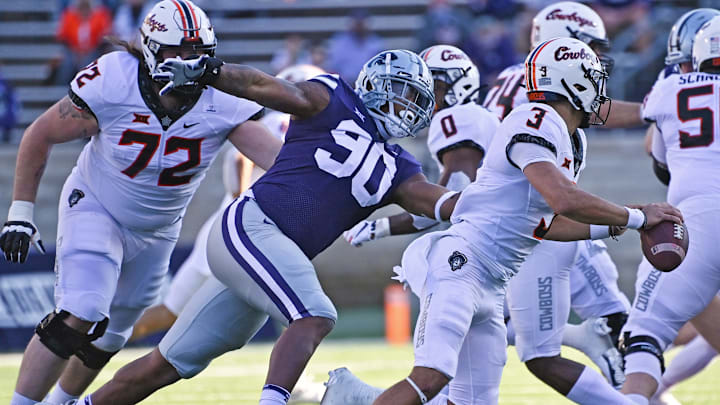 MANHATTAN, KS - NOVEMBER 07: Defensive end Tyrone Taleni #50 of the Kansas State Wildcats chases down quarterback Spencer Sanders #3 of the Oklahoma State Cowboys, during the first half at Bill Snyder Family Football Stadium on November 7, 2020 in Manhattan, Kansas. (Photo by Peter G. Aiken/Getty Images)