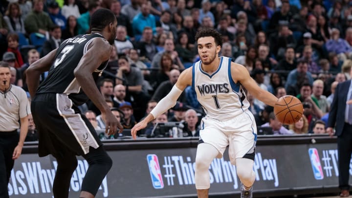 Mar 21, 2017; Minneapolis, MN, USA; Minnesota Timberwolves guard Tyus Jones (1) dribbles in the second quarter against the San Antonio Spurs center Dewayne Dedmon (3) at Target Center. Mandatory Credit: Brad Rempel-USA TODAY Sports