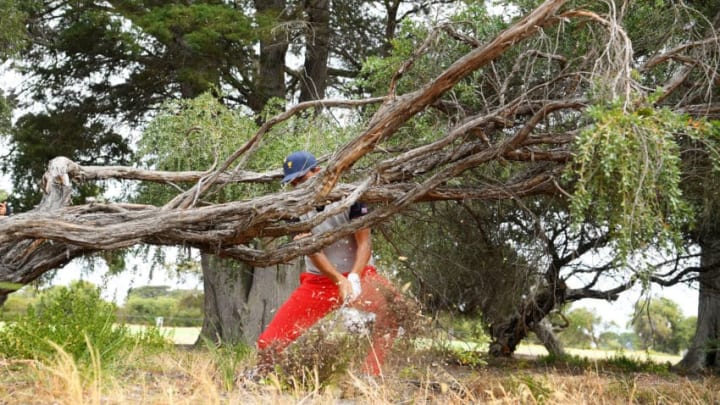 MELBOURNE, AUSTRALIA - DECEMBER 14: Rickie Fowler of the United States team plays a shot from the rough on the 18th hole during Saturday afternoon foursomes matches on day three of the 2019 Presidents Cup at Royal Melbourne Golf Course on December 14, 2019 in Melbourne, Australia. (Photo by Quinn Rooney/Getty Images)