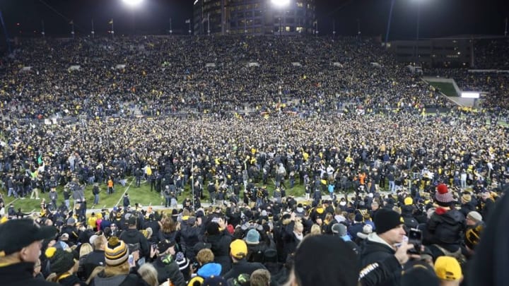 Nov 12, 2016; Iowa City, IA, USA; Fans storm the field after Iowa Hawkeyes place kicker Keith Duncan (not pictured) kicks the game-winning field goal against the Michigan Wolverines at Kinnick Stadium. The Hawkeyes won 14-13. Mandatory Credit: Reese Strickland-USA TODAY Sports