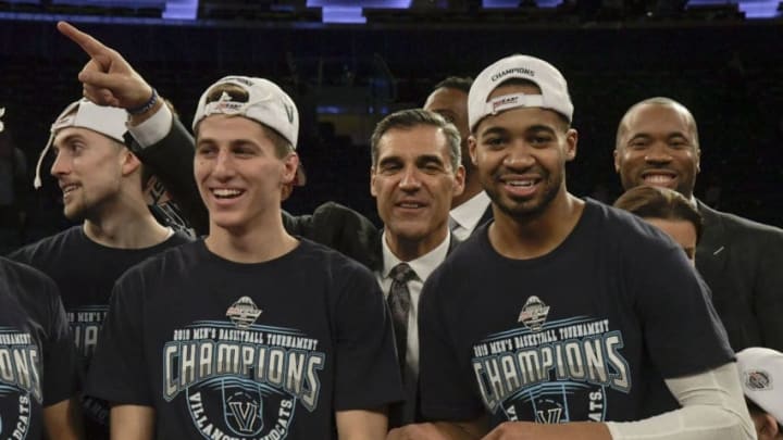 NEW YORK, NY - MARCH 16: Collin Gillespie #2 and Phil Booth #5 of the Villanova Wildcats celebrate with head coach Jay Wright after the Wildcats defeated the Seton Hall Pirates to win their third consecutive Big East Tournament championship at Madison Square Garden, on March 16, 2019 in New York City. (Photo by Porter Binks/Getty Images)