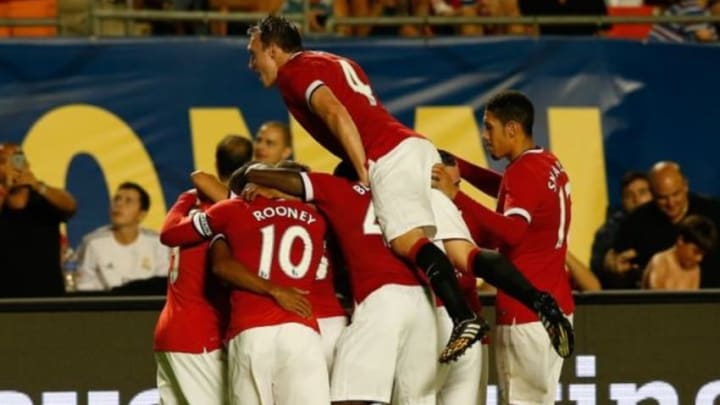 Aug 4, 2014; Miami Gardens, FL, USA; Manchester United defender Phil Jones (4) leaps teammates celebrating a goal by midfielder Jesse Lingard (35) in the second half against Liverpool at Sun Life Stadium. Mandatory Credit: Robert Mayer-USA TODAY Sports