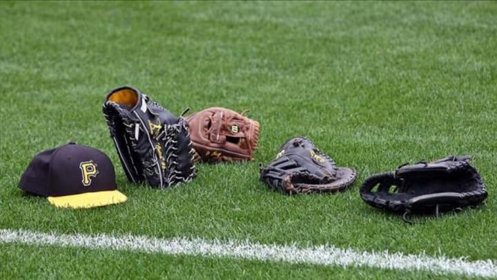 March 20, 2013; Lake Buena Vista, FL, USA; Pittsburgh Pirates gloves and a hat sit on the field before the game against the Atlanta Braves at Champion Stadium. Mandatory Credit: Rob Foldy-USA TODAY Sports