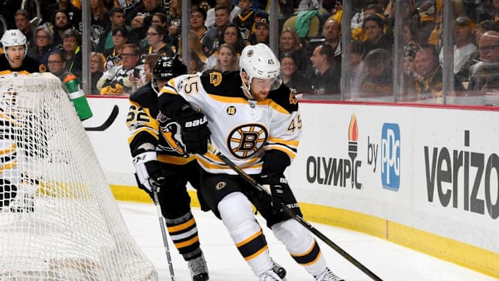 PITTSBURGH, PA - JANUARY 22: Joe Morrow #45 of the Boston Bruins handles the puck against Carl Hagelin #62 of the Pittsburgh Penguins at PPG Paints Arena on January 22, 2017 in Pittsburgh, Pennsylvania. (Photo by Joe Sargent/NHLI via Getty Images)