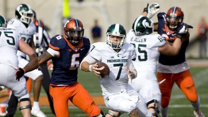 Nov 5, 2016; Champaign, IL, USA; Michigan State Spartans quarterback Tyler O'Connor (7) runs with the football against Illinois Fighting Illini defensive lineman Carroll Phillips (6) during the fourth quarter at Memorial Stadium. Illinois beat Michigan State 31-27. Mandatory Credit: Mike Granse-USA TODAY Sports