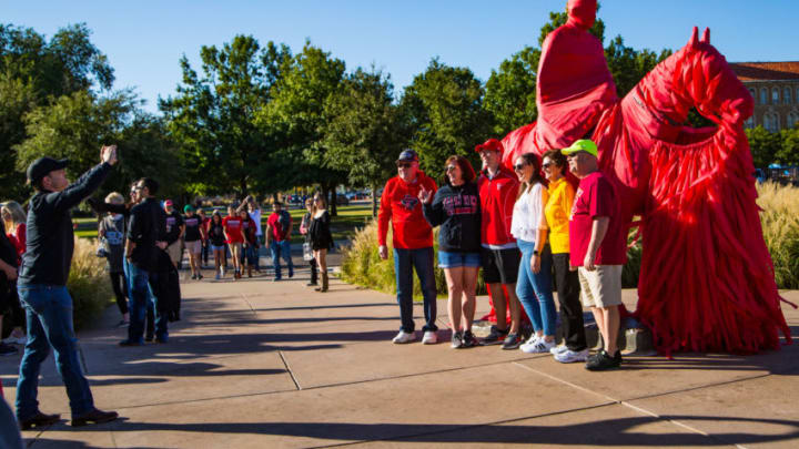 LUBBOCK, TEXAS - OCTOBER 19: Fans pose for a photo with the Will Rogers and Soapsuds statue before the college football game between the Texas Tech Red Raiders and the Iowa State Cyclones on October 19, 2019 at Jones AT&T Stadium in Lubbock, Texas. (Photo by John E. Moore III/Getty Images)