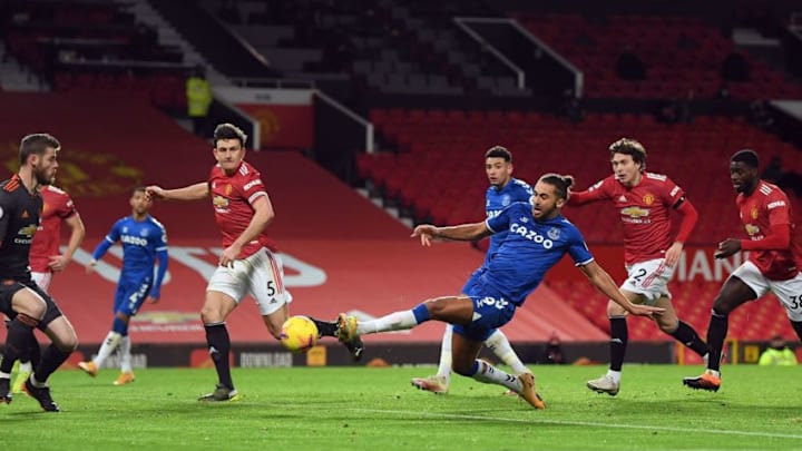 Everton's English striker Dominic Calvert-Lewin (3R) scores his team's third goal during the English Premier League football match between Manchester United and Everton at Old Trafford in Manchester, north west England, on February 6, 2021. (Photo by Michael Regan / POOL / AFP) / RESTRICTED TO EDITORIAL USE. No use with unauthorized audio, video, data, fixture lists, club/league logos or 'live' services. Online in-match use limited to 120 images. An additional 40 images may be used in extra time. No video emulation. Social media in-match use limited to 120 images. An additional 40 images may be used in extra time. No use in betting publications, games or single club/league/player publications. / (Photo by MICHAEL REGAN/POOL/AFP via Getty Images)