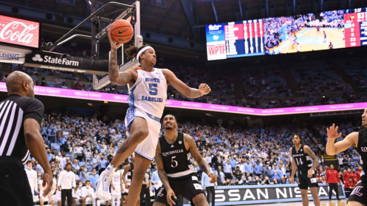 Feb 21, 2022; Chapel Hill, North Carolina, USA; North Carolina Tar Heels forward Armando Bacot (5) looks to pass as Louisville Cardinals forward Malik Williams (5) defends in the second half at Dean E. Smith Center. Mandatory Credit: Bob Donnan-USA TODAY Sports