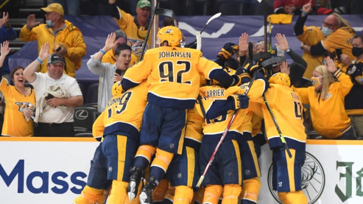 May 21, 2021; Nashville, Tennessee, USA; Nashville Predators players celebrate after the game-winning goal by center Matt Duchene (95) in the second overtime to beat the Carolina Hurricanes in game three of the first round of the 2021 Stanley Cup Playoffs at Bridgestone Arena. Mandatory Credit: Christopher Hanewinckel-USA TODAY Sports