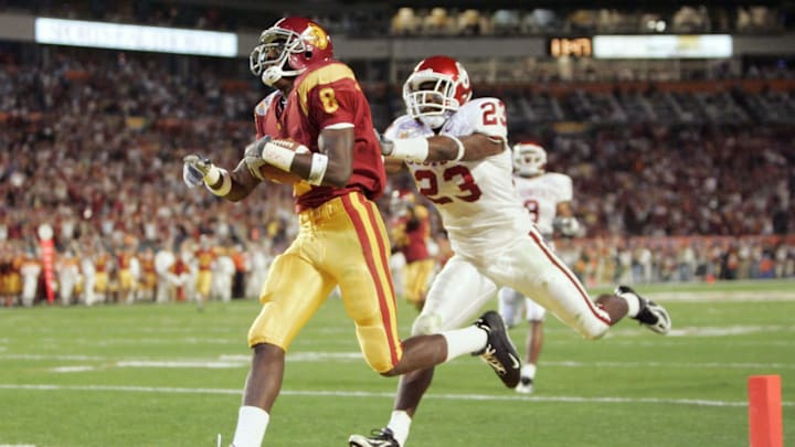 MIAMI – JANUARY 4: Wide receiver Dwayne Jarrett #8 of the USC Trojans scores on a 54-yard touchdown pass against Brodney Poole #23 of the Oklahoma Sooners during the second quarter of the FedEx Orange Bowl 2005 National Championship on January 4, 2005 at Pro Player Stadium in Miami, Florida. (Photo by Brian Bahr/Getty Images)