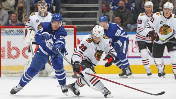 Auston Matthews #34 of the Toronto Maple Leafs tries to stop Brandon Hagel #38 of the Chicago Blackhawks. (Photo by Claus Andersen/Getty Images)