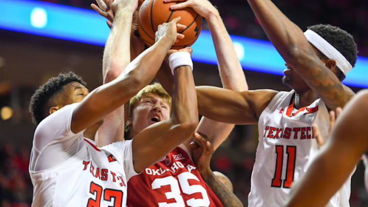 LUBBOCK, TX - JANUARY 08: Brady Manek #35 of the Oklahoma Sooners battles for the rebound with Jarrett Culver #23 and Tariq Owens #11 of the Texas Tech Red Raiders during the first half of the game on January 8, 2019 at United Supermarkets Arena in Lubbock, Texas. (Photo by John Weast/Getty Images)