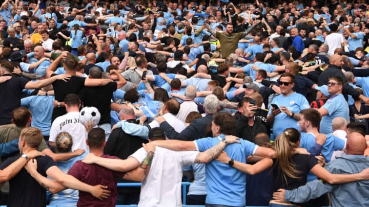 MANCHESTER, ENGLAND - MAY 22: Manchester City fans celebrate winning the Premier League title by doing the Poznan celebration after the Premier League match between Manchester City and Aston Villa at Etihad Stadium on May 22, 2022 in Manchester, England. (Photo by Stu Forster/Getty Images)