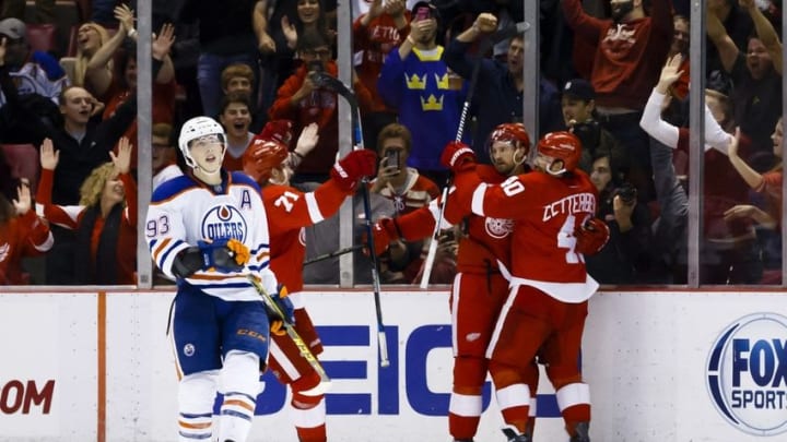 Nov 27, 2015; Detroit, MI, USA; Detroit Red Wings defenseman Niklas Kronwall (55) receives congratulations from left wing Henrik Zetterberg (40) as Edmonton Oilers center Ryan Nugent-Hopkins (93) reacts to an overtime goal by Kronwall at Joe Louis Arena. Detroit won 4-3 in overtime. Mandatory Credit: Rick Osentoski-USA TODAY Sports