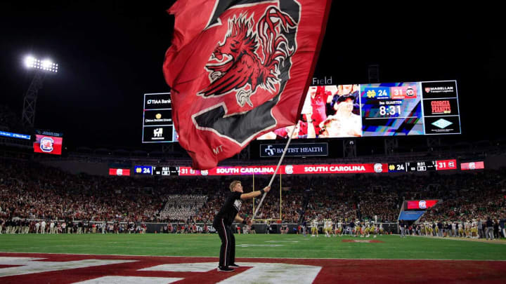 A South Carolina Gamecocks cheerleader waves the flag after a score during the third quarter of the TaxSlayer Gator Bowl of an NCAA college football game Friday, Dec 30, 2022, at TIAA Bank Field in Jacksonville. The Notre Dame Fighting Irish held off the South Carolina Gamecocks 45-38. [Corey Perrine/Florida Times-Union]