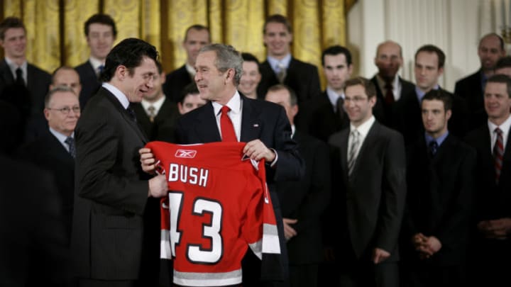 WASHINGTON - FEBRUARY 2: US President George W. Bush receives a jersey from hockey player Rod Brind'Amour on February 2, 2007 in the East Room of the White House in Washington, D.C. Bush hosted the 2006 Stanley Cup champion Carolina Hurricanes. (Photo by Charles Ommanney/Getty Images)