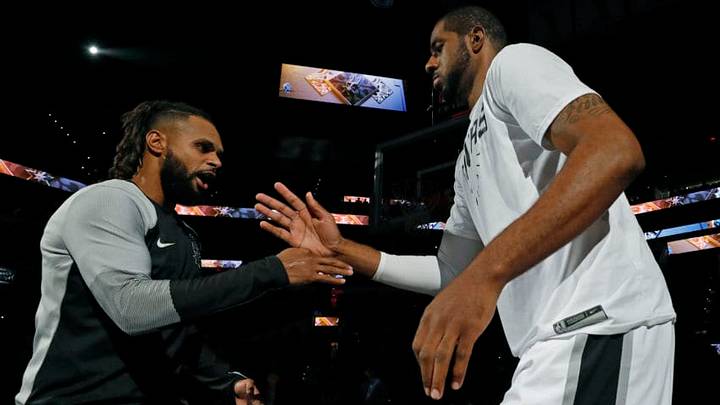 SAN ANTONIO, TX - OCTOBER 7: Patty Mills #8 of the San Antonio Spurs and teammate LaMarcus Aldridge #12 high five before a preseason game against the Houston Rockets on October 7, 2018 at the AT&T Center in San Antonio, Texas. NOTE TO USER: User expressly acknowledges and agrees that, by downloading and or using this photograph, User is consenting to the terms and conditions of the Getty Images License Agreement. (Photo by Edward A. Ornelas/Getty Images)