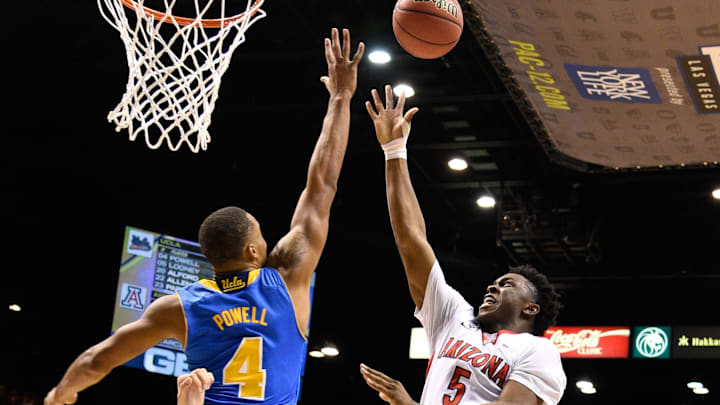 March 13, 2015; Las Vegas, NV, USA; Arizona Wildcats forward Stanley Johnson (5) shoots the basketball against UCLA Bruins guard Norman Powell (4) during the first half in the semifinal round of the Pac-12 Conference tournament at MGM Grand Garden Arena. Mandatory Credit: Kyle Terada-USA TODAY Sports