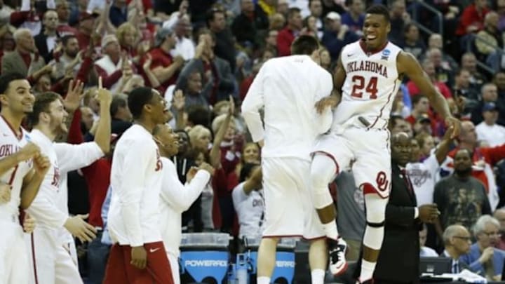Mar 22, 2015; Columbus, OH, USA; Oklahoma Sooners guard Buddy Hield (24) jumps in the air in celebration with his teammates after the game against the Dayton Flyers in the third round of the 2015 NCAA Tournament at Nationwide Arena. Oklahoma won 72-66. Mandatory Credit: Greg Bartram-USA TODAY Sports Mar 22, 2015; Columbus, OH, USA; Oklahoma Sooners guard Buddy Hield (24) jumps in the air in celebration with his teammates after the game against the Dayton Flyers in the third round of the 2015 NCAA Tournament at Nationwide Arena. Oklahoma won 72-66. Mandatory Credit: Greg Bartram-USA TODAY Sports