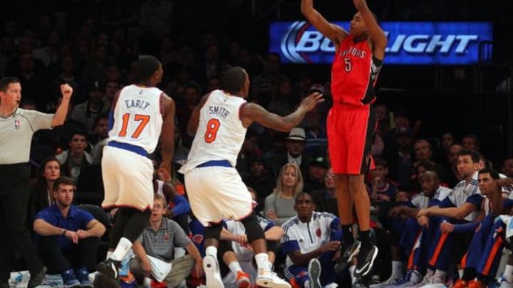 Oct 13, 2014; New York, NY, USA; Toronto Raptors small forward Bruno Caboclo (5) shoots over New York Knicks small forward Cleanthony Early (17) and New York Knicks shooting guard J.R. Smith (8) during the third quarter at Madison Square Garden. Mandatory Credit: Brad Penner-USA TODAY Sports