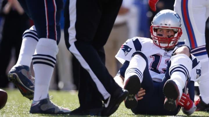 Oct 12, 2014; Orchard Park, NY, USA; New England Patriots quarterback Tom Brady (12) on the turf after a sack by the Buffalo Bills defense at Ralph Wilson Stadium. Mandatory Credit: Kevin Hoffman-USA TODAY Sports