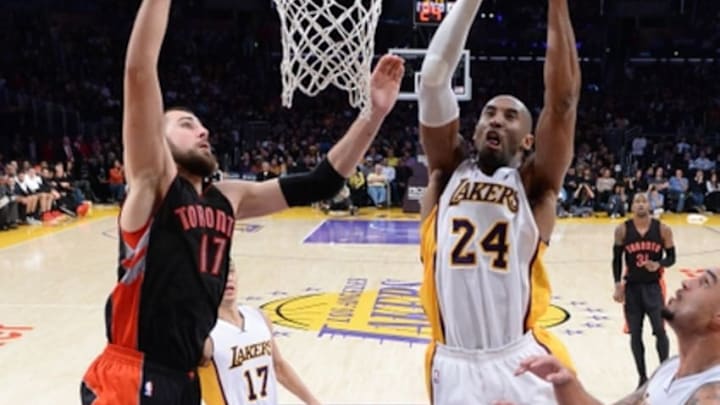 Nov 30, 2014; Los Angeles, CA, USA; Los Angeles Lakers guard Kobe Bryant (24) grabs a rebound in front of Toronto Raptors center Jonas Valanciunas (17) during the game at Staples Center. Lakers won 129-122 in overtime. Mandatory Credit: Jayne Kamin-Oncea-USA TODAY Sports