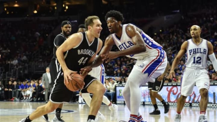 Dec 18, 2016; Philadelphia, PA, USA; Brooklyn Nets guard Bojan Bogdanovic (44) drives to the net as Philadelphia 76ers center Joel Embiid (21) defends during the third quarter of the game at the Wells Fargo Center. The Sixers won the game 108-107. Mandatory Credit: John Geliebter-USA TODAY Sports