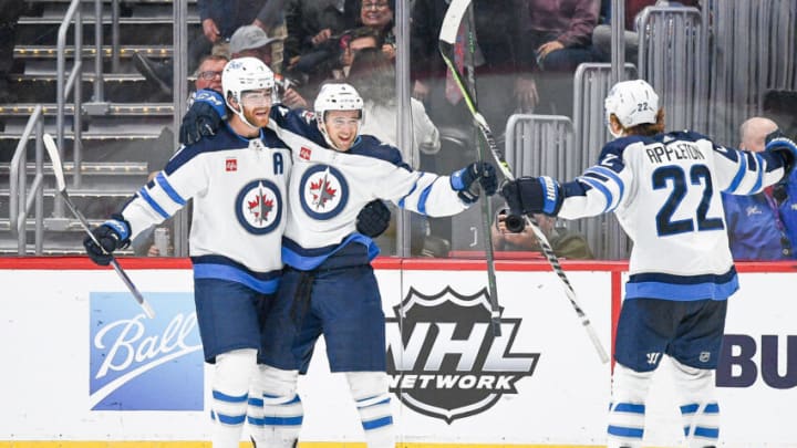 DENVER, COLORADO - OCTOBER 19: Neal Pionk #4 of the Winnipeg Jets celebrates a game-winning overttime goal with teammates Adam Lowry #17 and Mason Appleton #22 against the Colorado Avalanche an at Ball Arena on October 19, 2022 in Denver, Colorado. (Photo by Dustin Bradford/Getty Images)