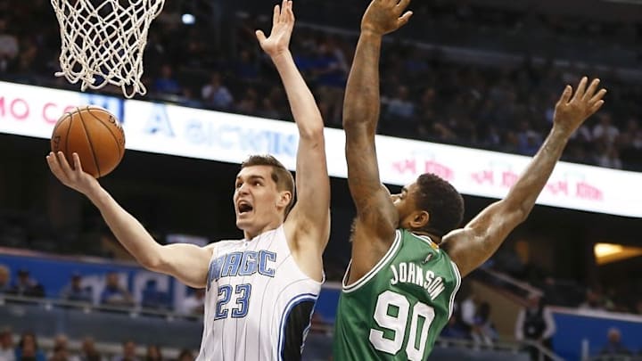 Jan 31, 2016; Orlando, FL, USA; Orlando Magic guard Mario Hezonja (23) shoots around Boston Celtics forward Amir Johnson (90) during the first quarter of a basketball game at Amway Center. Mandatory Credit: Reinhold Matay-USA TODAY Sports