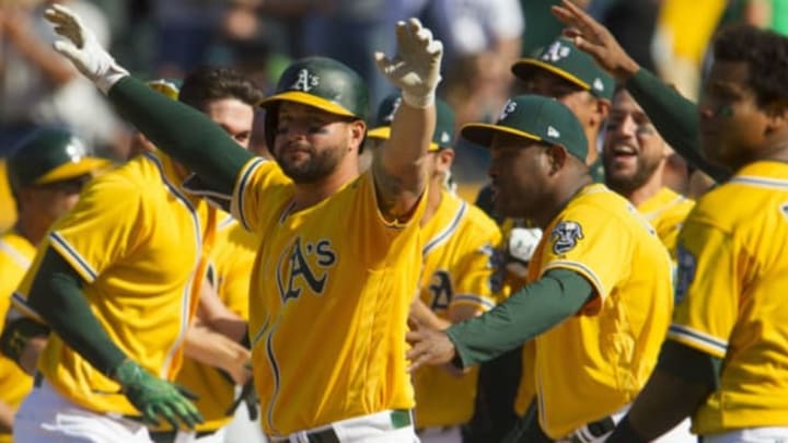 May 7, 2017; Oakland, CA, USA; Oakland Athletics first baseman Yonder Alonso (17) celebrates with his team after a walk off two run home run by Athletics designated hitter Ryan Healy (not pictured) against the Detroit Tigers at Oakland Coliseum. The Athletics won 8-6. Mandatory Credit: Andrew Villa-USA TODAY Sports