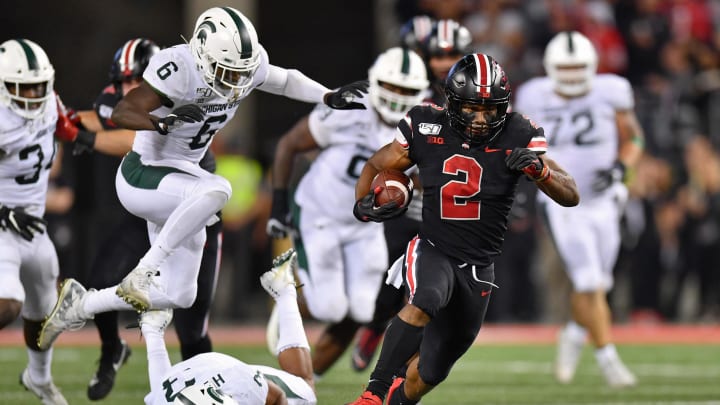 COLUMBUS, OH – OCTOBER 5: J.K. Dobbins #2 of the Ohio State Buckeyes takes off on a 67-yard touchdown run in the second quarter as David Dowell #6 of the Michigan State Spartans gives pursuit at Ohio Stadium on October 5, 2019 in Columbus, Ohio. (Photo by Jamie Sabau/Getty Images)