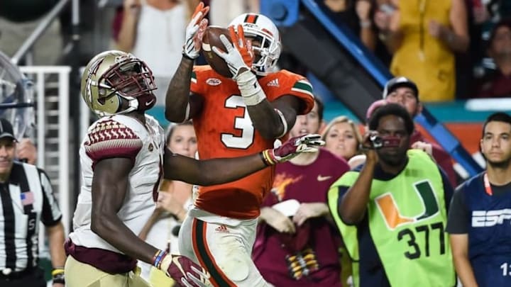 Oct 8, 2016; Miami Gardens, FL, USA; Miami Hurricanes wide receiver Stacy Coley (3) hauls in a touchdown catch in front of Florida State Seminoles defensive back Tarvarus McFadden (4) during the second half at Hard Rock Stadium. FSU won 20-19. Mandatory Credit: Steve Mitchell-USA TODAY Sports