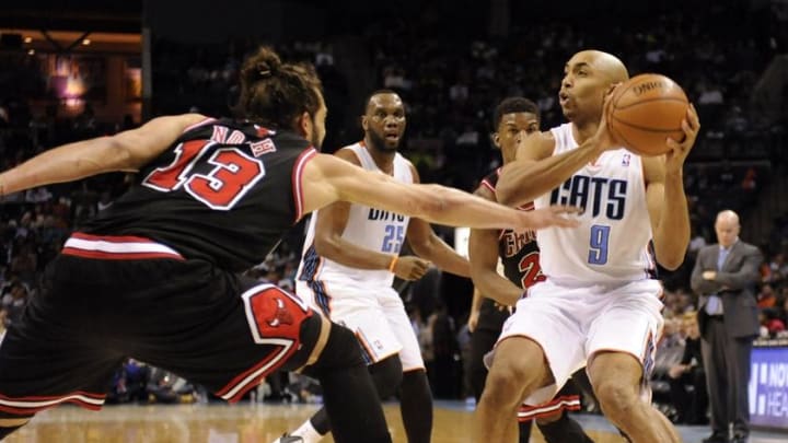 Apr 16, 2014; Charlotte, NC, USA; Charlotte Bobcats guard Gerald Henderson (9) looks to pass as he is defended by Chicago Bulls center Joakim Noah (13) during the second half of the game at Time Warner Cable Arena. Bobcats win in overtime 91-86. Mandatory Credit: Sam Sharpe-USA TODAY Sports