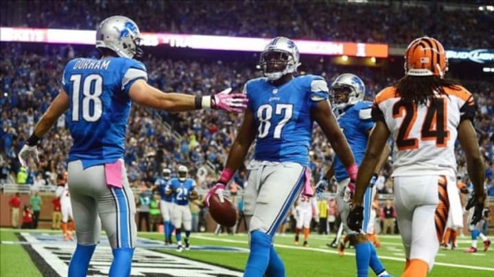 Oct 20, 2013; Detroit, MI, USA; Detroit Lions tight end Brandon Pettigrew (87) celebrates with wide receiver Kris Durham (18) after catching a pass in the end zone for a touchdown during the first quarter against the Cincinnati Bengals at Ford Field. Mandatory Credit: Andrew Weber-USA TODAY Sports