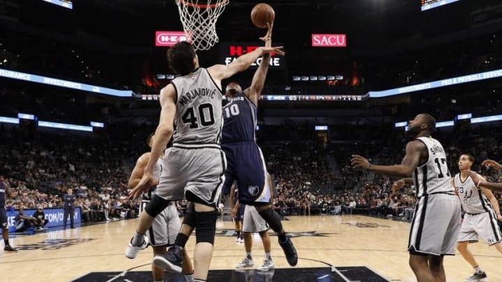 Apr 17, 2016; San Antonio, TX, USA; Memphis Grizzlies power forward Jarell Martin (10) shoots the ball as San Antonio Spurs center Boban Marjanovic (40) defends during the second half in game one of the first round of the NBA Playoffs at AT&T Center. Mandatory Credit: Soobum Im-USA TODAY Sports