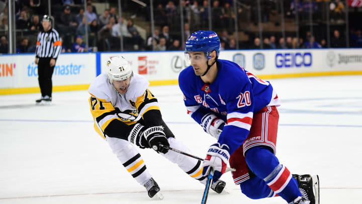 NEW YORK, NEW YORK – NOVEMBER 12: Chris Kreider #20 of the New York Rangers controls the puck with pressure from Evgeni Malkin #71 of the Pittsburgh Penguins during their game at Madison Square Garden on November 12, 2019 in New York City. (Photo by Emilee Chinn/Getty Images)