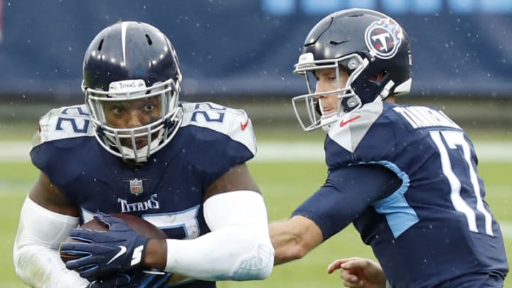 NASHVILLE, TENNESSEE - OCTOBER 18: Running back Derrick Henry #22 of the Tennessee Titans takes the hand-off from quarterbackRyan Tannehill #17 and runs with the ball in the first quarter against the Houston Texans at Nissan Stadium on October 18, 2020 in Nashville, Tennessee. The Titans defeated the Texans 42-36 in overtime. (Photo by Frederick Breedon/Getty Images)