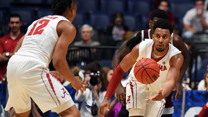 Mar 9, 2017; Nashville, TN, USA; Alabama Crimson Tide forward Braxton Key (25) passes the ball to guard Dazon Ingram (12) during the second half against the Mississippi State Bulldogs during the SEC Conference Tournament at Bridgestone Arena. Alabama won 75-55. Mandatory Credit: Christopher Hanewinckel-USA TODAY Sports