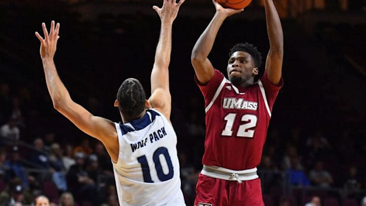 LAS VEGAS, NEVADA - NOVEMBER 23: Carl Pierre #12 of the Massachusetts Minutemen shoots against Caleb Martin #10 of the Nevada Wolf Pack during the championship game of the 2018 Continental Tire Las Vegas Holiday Invitational basketball tournament at the Orleans Arena on November 23, 2018 in Las Vegas, Nevada. Nevada defeated Massachusetts 110-87. (Photo by Sam Wasson/Getty Images)