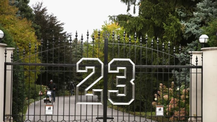HIGHLAND PARK, IL - OCTOBER 21: A gate with the number 23 controls access to the home of basketball legend Michael Jordan on October 21, 2013 in Highland Park, Illinois. Twenty-three is the number Jordan wore while playing basketball for the Chicago Bulls. The home which had been offered for sale for $29 million and later dropped to $21 million is scheduled to be sold at auction on November 22. The 32,683-squre-foot home features nine bedrooms, 19 bathrooms, a 15-car attached garage and an "NBA-quality" basketball court. (Photo by Scott Olson/Getty Images)
