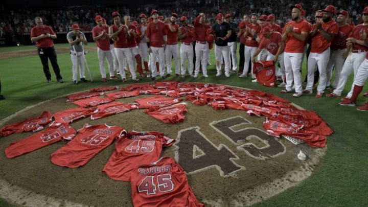 ANAHEIM, CA - JULY 12: Los Angeles Angels of Anaheim players lay their jerseys on the pitchers mound after they won a combined no-hitter against the Seattle Mariners at Angel Stadium of Anaheim on July 12, 2019 in Anaheim, California. The entire Angels team wore Tyler Skaggs #45 jersey to honor him after his death on July 1. Angels won 13-0. Los Angeles Angels public relations employee Eric Kay is seen on left. (Photo by John McCoy/Getty Images)