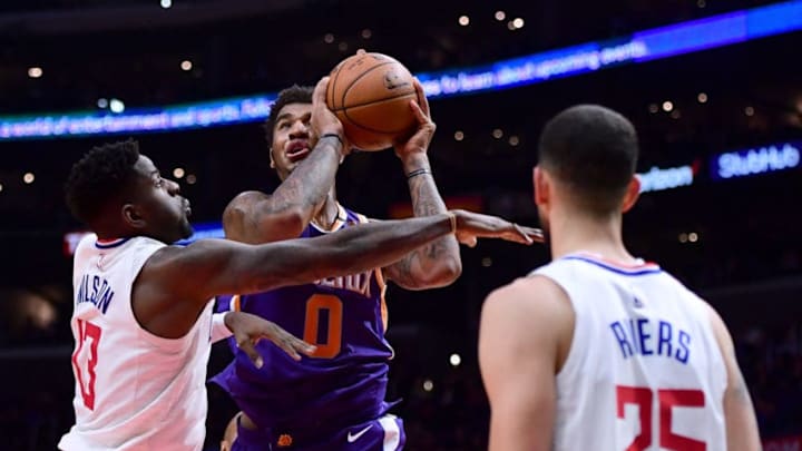LOS ANGELES, CA - DECEMBER 20: Marquese Chriss #0 of the Phoenix Suns attempts a shot between the defense of Jamil Wilson #13 and Austin Rivers #25 during a 108-95 Clipper win at Staples Center on December 20, 2017 in Los Angeles, California. (Photo by Harry How/Getty Images)