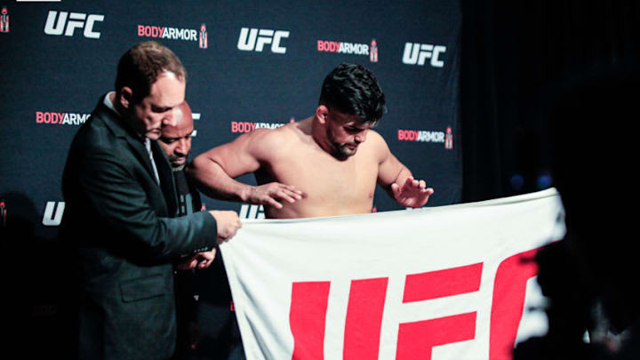 Kelvin Gastelum weighs in at UFC 244 and appear to be leaning on his coach (photo by Amy Kaplan/FanSided)