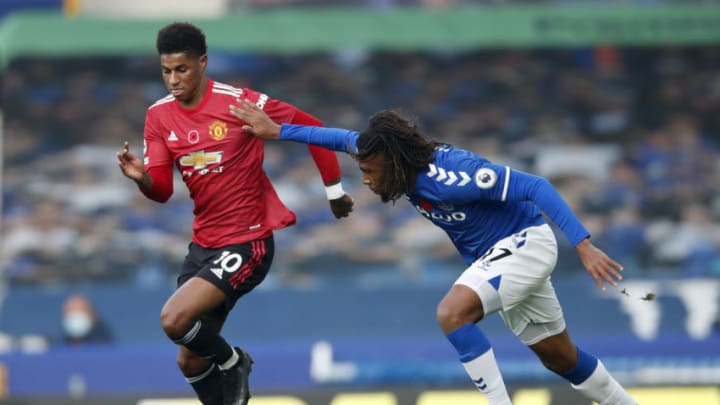 LIVERPOOL, ENGLAND - NOVEMBER 07: Marcus Rashford of Manchester United is challenged by Alex Iwobi of Everton during the Premier League match between Everton and Manchester United at Goodison Park on November 07, 2020 in Liverpool, England. Sporting stadiums around the UK remain under strict restrictions due to the Coronavirus Pandemic as Government social distancing laws prohibit fans inside venues resulting in games being played behind closed doors. (Photo by Clive Brunskill/Getty Images)