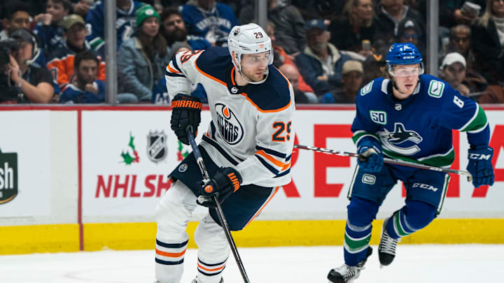 VANCOUVER, BC – DECEMBER 01: Leon Draisaitl #29 of the Edmonton Oilers skates with the puck while Brock Boeser #6 of the Vancouver Canucks gives chase during NHL action at Rogers Arena on December 1, 2019 in Vancouver, Canada. (Photo by Rich Lam/Getty Images)