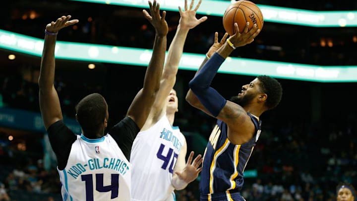 Nov 7, 2016; Charlotte, NC, USA; Indiana Pacers forward Paul George (13) shoots the ball over Charlotte Hornets forward Cody Zeller (40) and forward Michael Kidd-Gilchrist (14) in the first half at Spectrum Center. Mandatory Credit: Jeremy Brevard-USA TODAY Sports