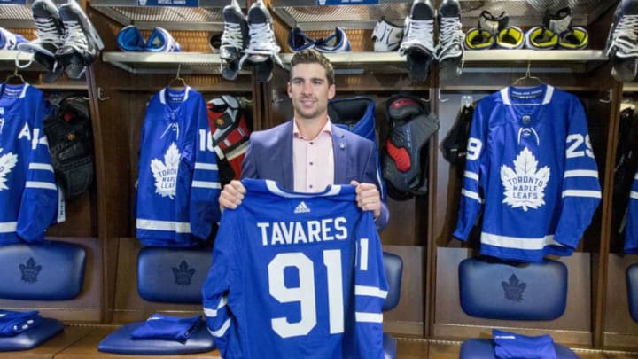 TORONTO, ON - JULY 1 -Tavares posing with his jersey in the Leafs locker room.The Toronto Maple Leafs have signed John Tavares for seven years, $77 million. July 1, 2018. (Carlos Osorio/Toronto Star via Getty Images)