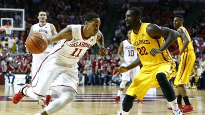 Feb 9, 2015; Norman, OK, USA; Oklahoma Sooners guard Isaiah Cousins (11) drives to the basket against Iowa State Cyclones forward Dustin Hogue (22) during the second half at Lloyd Noble Center. Oklahoma won 94-83. Mandatory Credit: Alonzo Adams-USA TODAY Sports