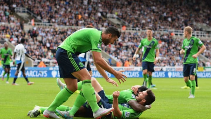 NEWCASTLE UPON TYNE, ENGLAND – AUGUST 09: Shane Long of Southampton (7) celebrates with Victor Wanyama (12) and Graziano Pelle (L) as he scores their second goal during the Barclays Premier League match between Newcastle United and Southampton at St James’ Park on August 9, 2015 in Newcastle upon Tyne, England. (Photo by Nigel Roddis/Getty Images)